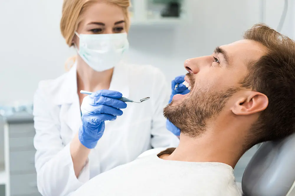 Dentist looking into patients mouth